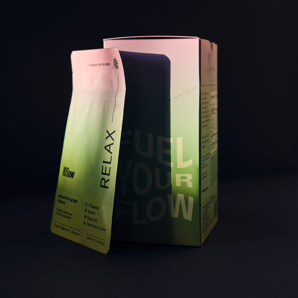 Green and pink box of Hiflow Relax gum, with 'Fuel your flow' text. Shot on a black background.